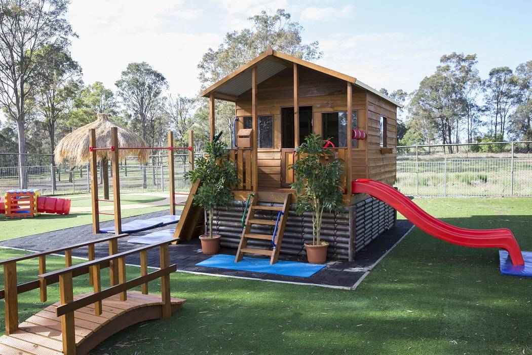 Castle Cubby with 900mm elevation kit, Bali Umbrella, Monkey Bars, bamboo, and Garden Bridge for a NSW Childcare Centre